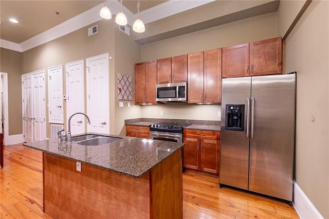 kitchen featuring light hardwood / wood-style flooring, decorative light fixtures, stainless steel appliances, and sink