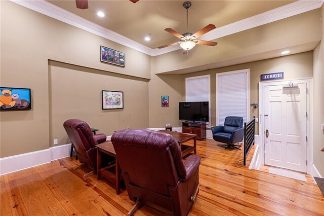 living room with light wood-type flooring, crown molding, and ceiling fan