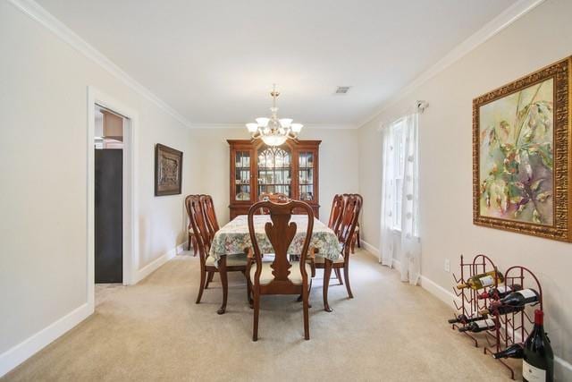 carpeted dining space featuring an inviting chandelier and ornamental molding