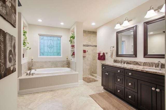 bathroom with vanity and independent shower and bath