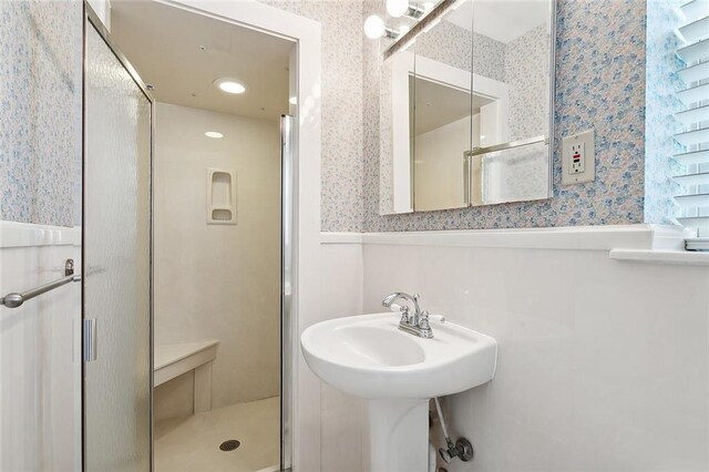 bathroom with a shower with shower door