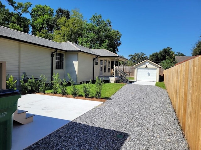 view of home's exterior featuring a garage and an outbuilding