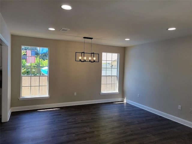 unfurnished dining area featuring a wealth of natural light, baseboards, dark wood-type flooring, and recessed lighting