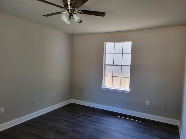 spare room featuring ceiling fan, baseboards, and dark wood-style flooring