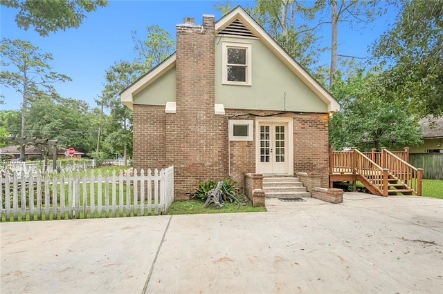 rear view of house featuring a patio area and a deck