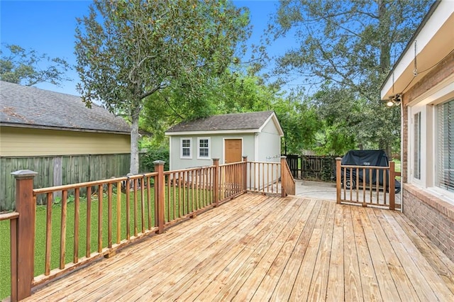 wooden deck with a yard and a shed