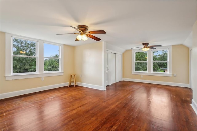 bonus room featuring ceiling fan, lofted ceiling, plenty of natural light, and dark hardwood / wood-style flooring