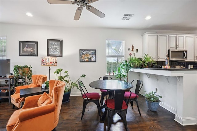 dining room featuring dark wood-type flooring and ceiling fan