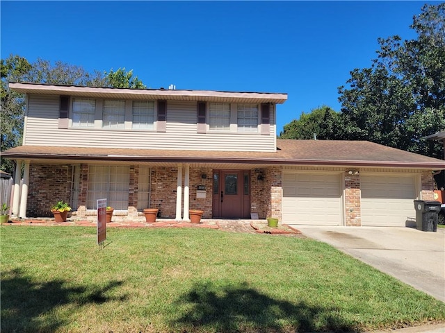 view of property featuring a garage, a front lawn, and covered porch