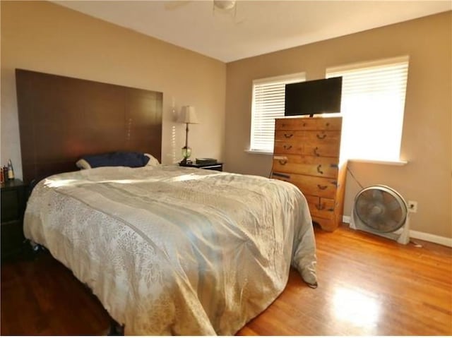 bedroom with ceiling fan and hardwood / wood-style flooring