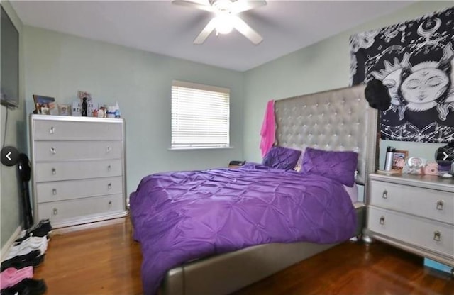 bedroom with ceiling fan and dark hardwood / wood-style floors