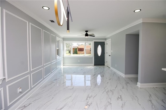 entrance foyer featuring ornamental molding and ceiling fan