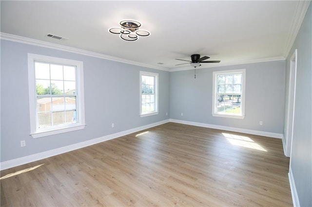 spare room featuring crown molding, ceiling fan, and light wood-type flooring