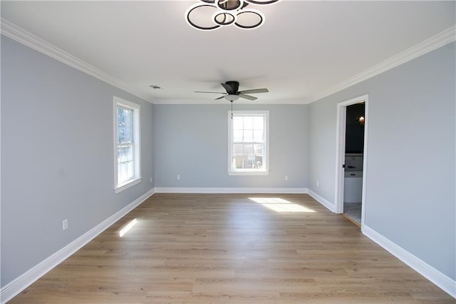 spare room with crown molding, light hardwood / wood-style floors, and ceiling fan