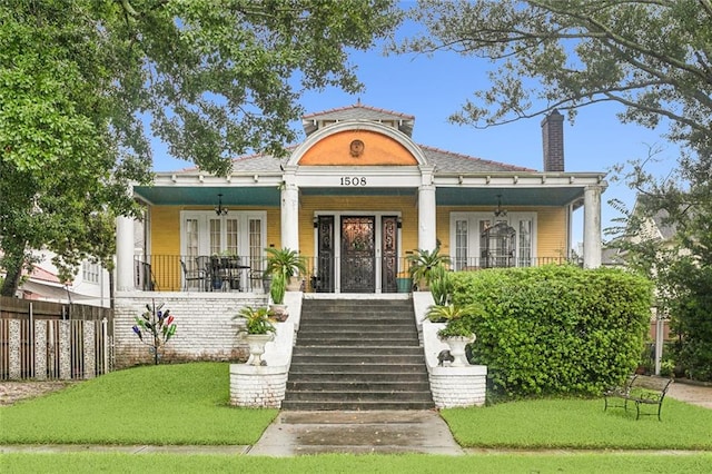 exterior space with a lawn and covered porch