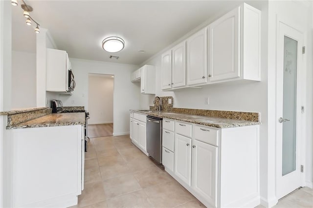 kitchen featuring appliances with stainless steel finishes, light stone counters, sink, and white cabinets