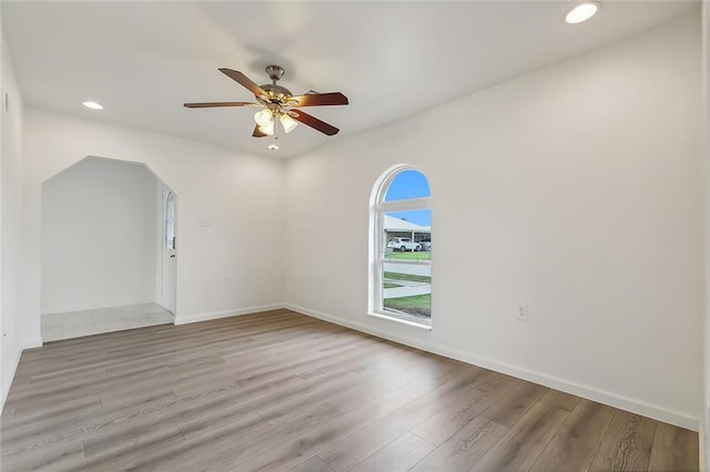 unfurnished room with ceiling fan and wood-type flooring