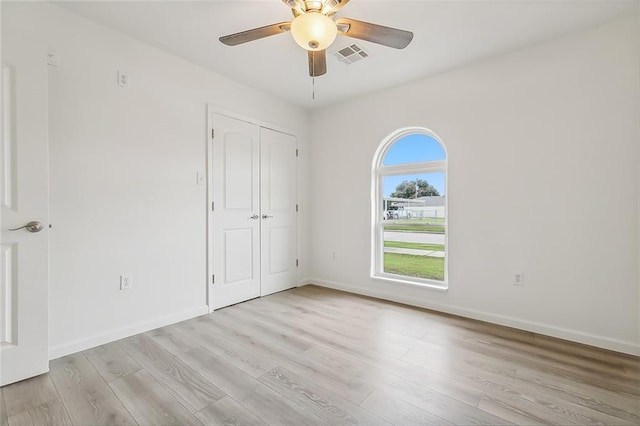 spare room featuring ceiling fan and light hardwood / wood-style floors