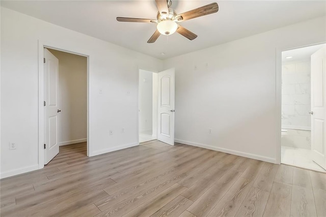 unfurnished bedroom featuring connected bathroom, ceiling fan, and light hardwood / wood-style floors