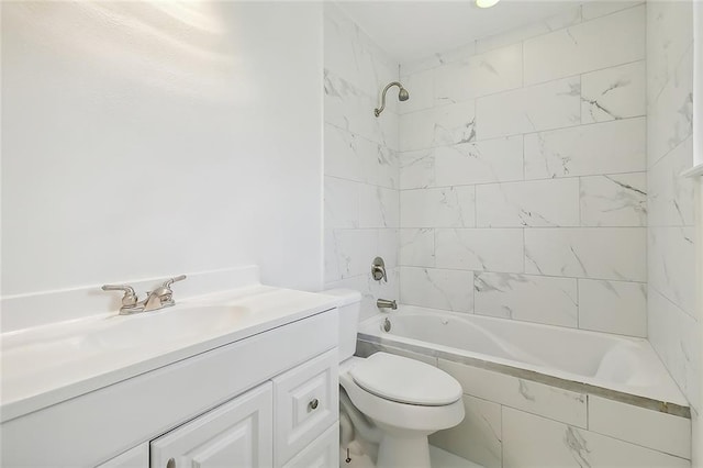 full bathroom featuring tiled shower / bath, toilet, and vanity