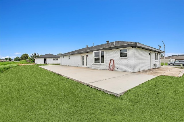 back of house with a lawn and a patio