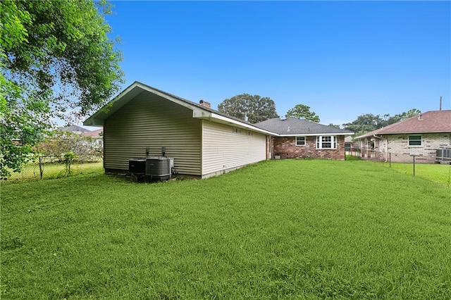 exterior space with cooling unit and a lawn