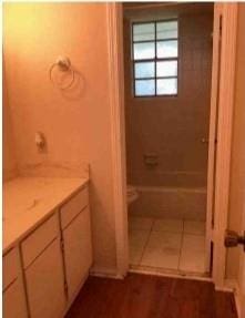 bathroom with vanity, toilet, a shower, and tile patterned floors