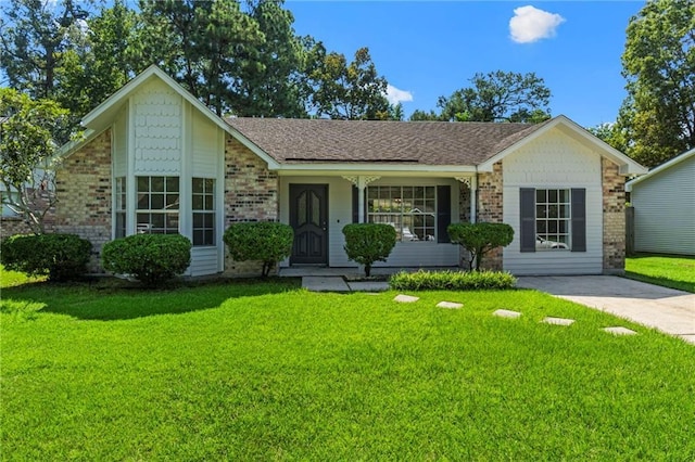 ranch-style home featuring covered porch and a front lawn