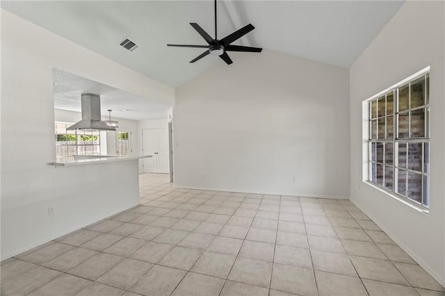 unfurnished living room with light tile patterned floors, vaulted ceiling, and ceiling fan