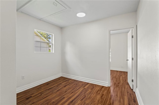 spare room with dark hardwood / wood-style flooring