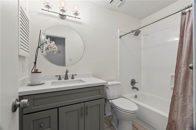 full bathroom with tile patterned floors, shower / bath combination with curtain, a textured ceiling, toilet, and vanity