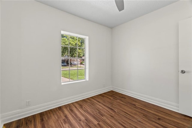 empty room with ceiling fan, wood-type flooring, and a wealth of natural light