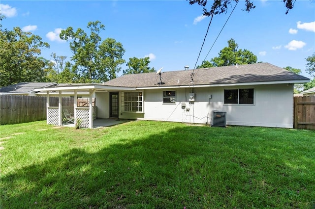 rear view of house with a yard, a patio, and central AC unit