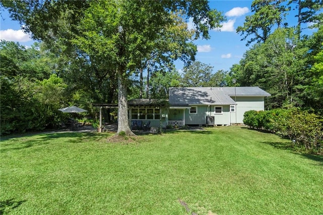 rear view of house with a yard