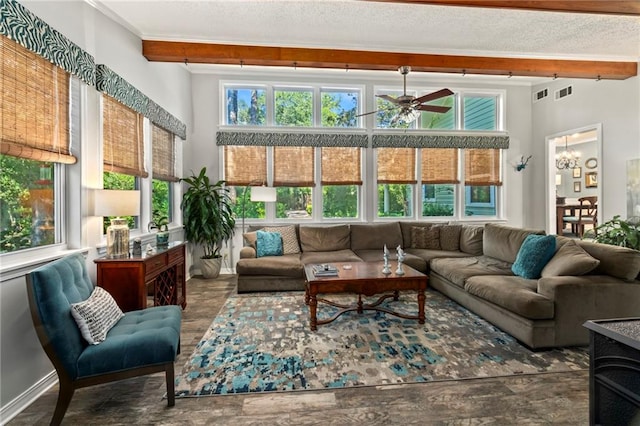 living room with a textured ceiling and ceiling fan