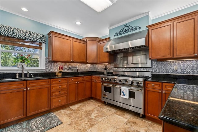 kitchen with ornamental molding, range with two ovens, sink, and wall chimney exhaust hood