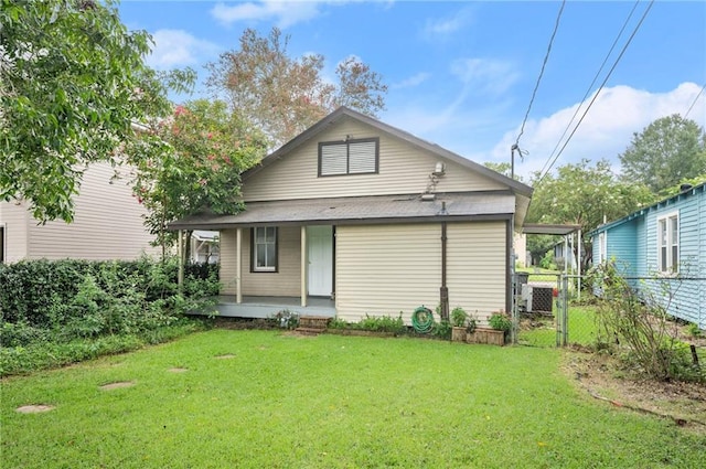 back of house featuring a yard and covered porch