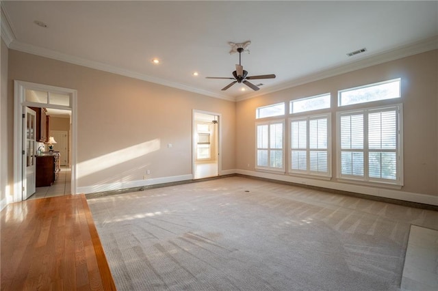 unfurnished room with ornamental molding, light wood-type flooring, and ceiling fan