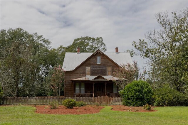 view of front of property with covered porch and a front yard