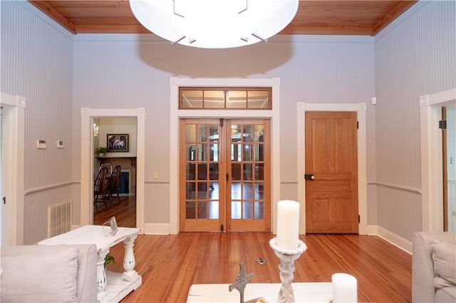 dining room featuring wood finished floors, wood ceiling, french doors, and visible vents