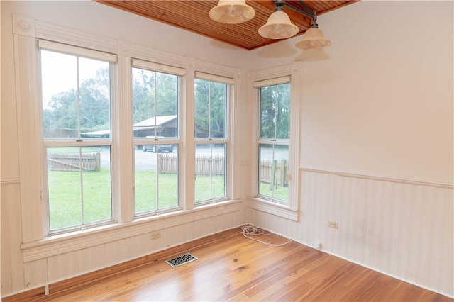 unfurnished sunroom with visible vents and a healthy amount of sunlight