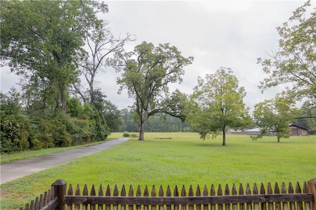 view of property's community with a yard and fence