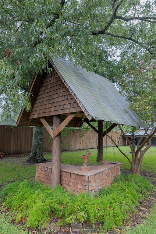 surrounding community with a gazebo, a lawn, and fence