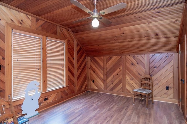 additional living space with vaulted ceiling, wooden walls, wood ceiling, and wood finished floors