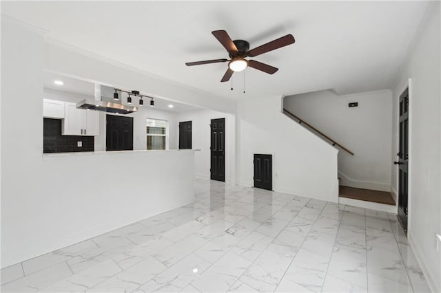 unfurnished living room with ceiling fan