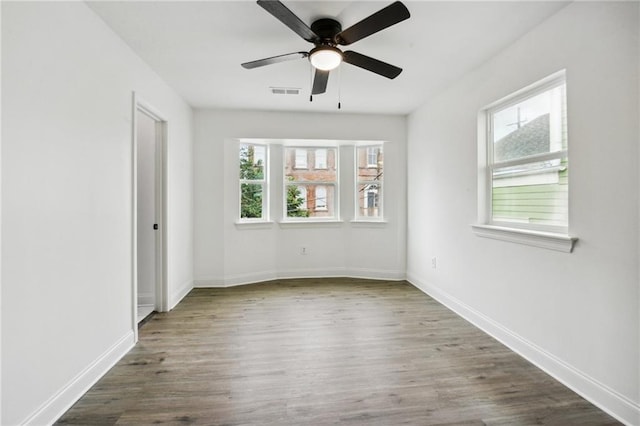 unfurnished room with hardwood / wood-style floors and ceiling fan