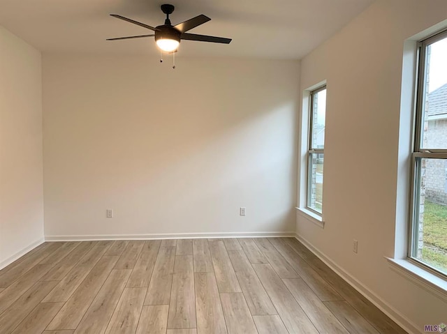 unfurnished room featuring ceiling fan, a healthy amount of sunlight, and light hardwood / wood-style floors