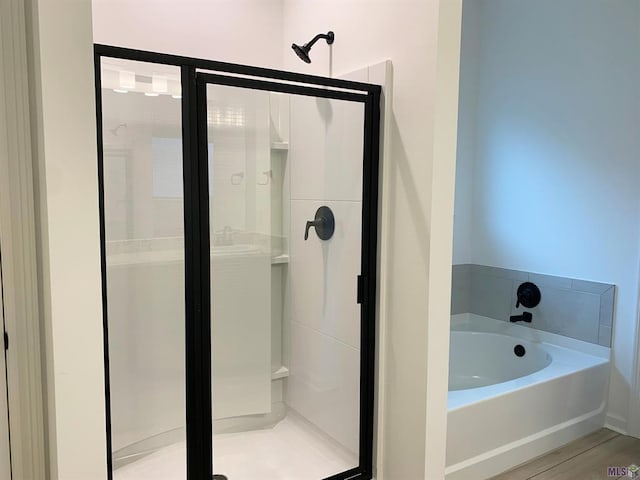 bathroom featuring hardwood / wood-style floors and shower with separate bathtub