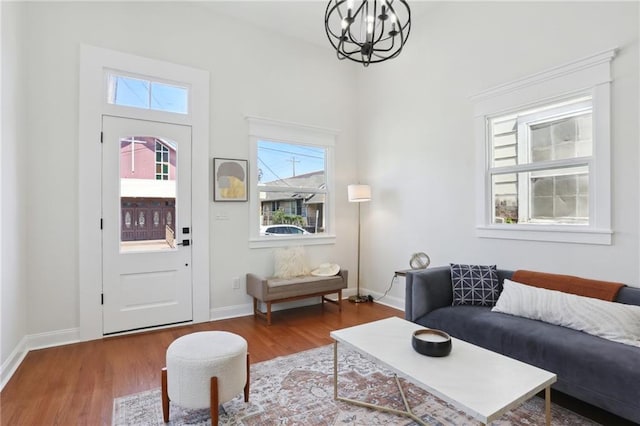 living room with hardwood / wood-style flooring, a notable chandelier, and a healthy amount of sunlight