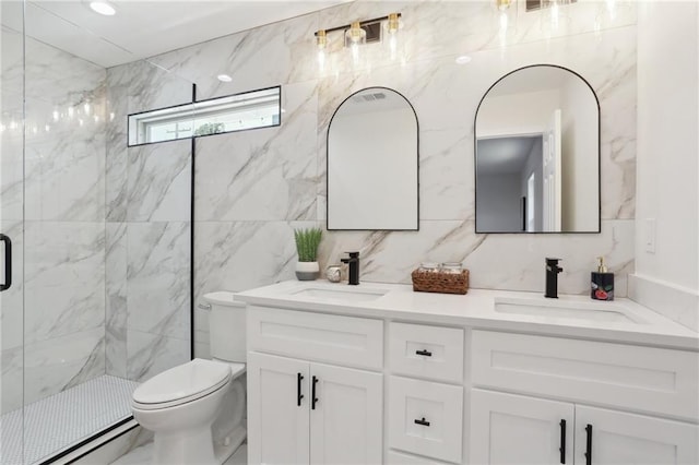 bathroom with a sink, a marble finish shower, toilet, and double vanity